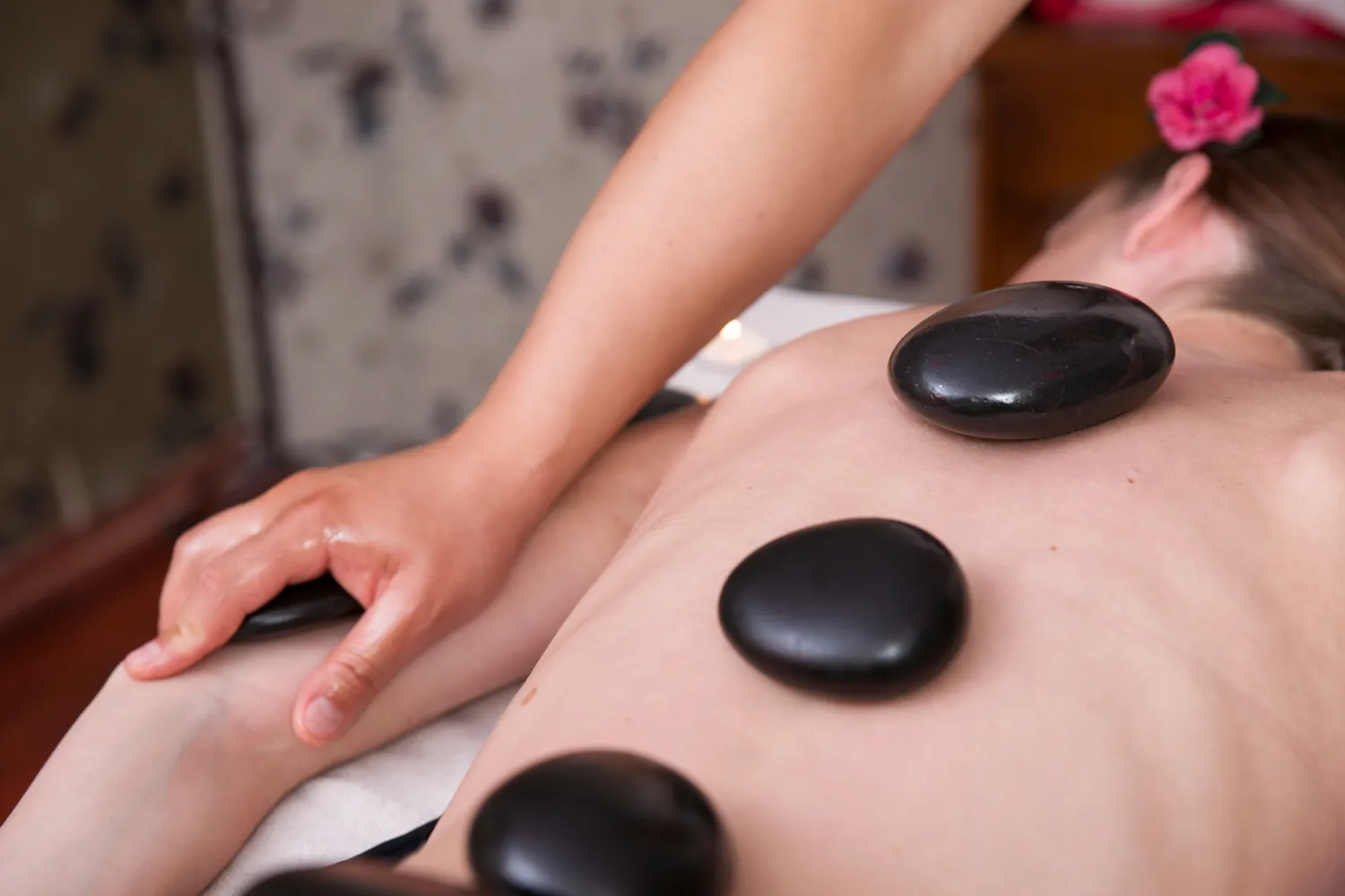 Hot stone massage therapy with heated stones for muscle relaxation